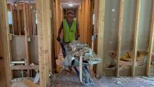 A volunteer helps clean up a home after devastating flooding in Eastern Kentucky.