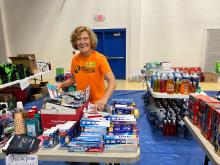 A volunteer sorts items for pickup at CAP's flood relief distribution center in Floyd County.