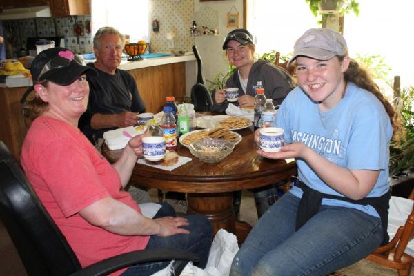 Kelly Yurt and her daughters, Kennedy and Kendra, have fun at an impromptu tea party hosted by the homeowner at their YouthFest worksite.