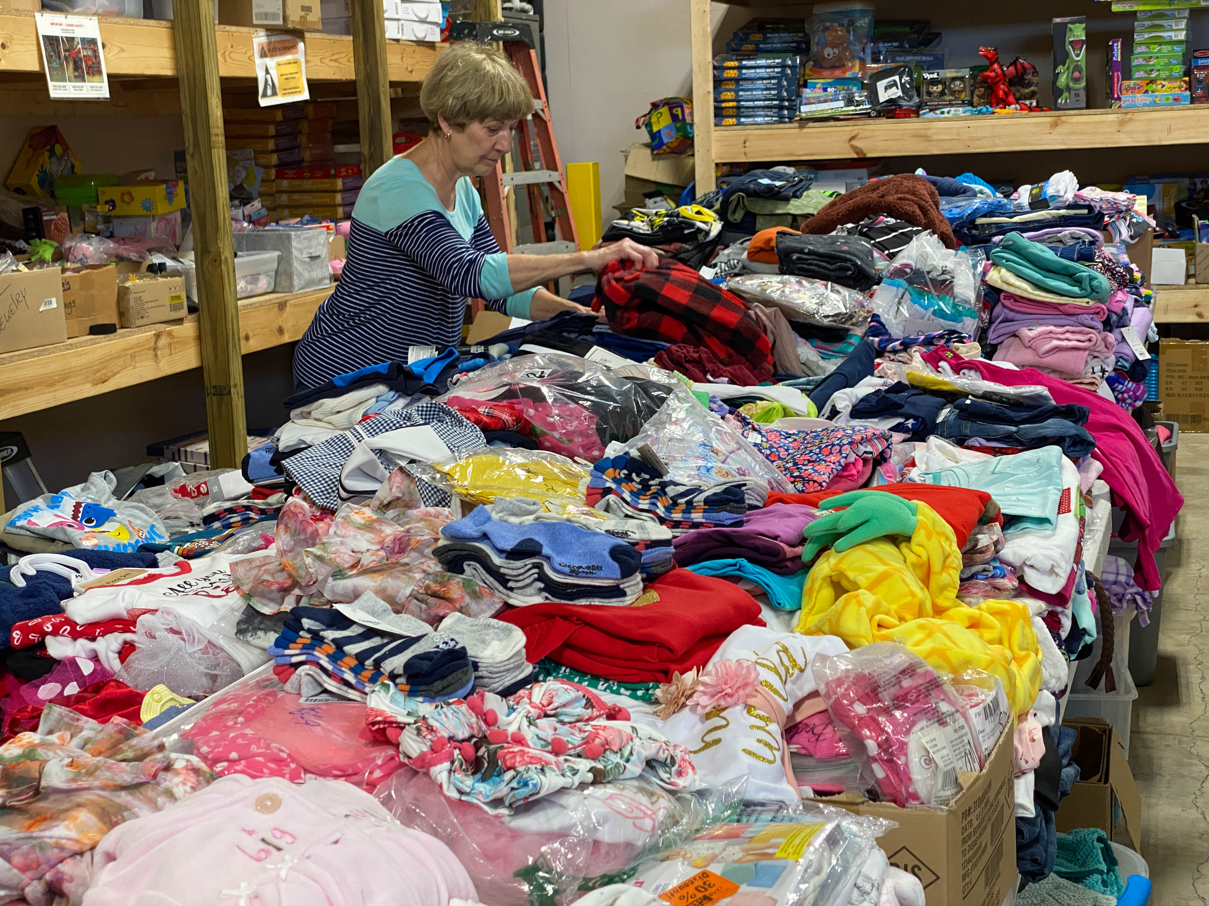 Volunteer sorting donations for Christmas blankets