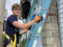 Stephen Butler, University of Scranton student, works on a home repair project during WorkFest.