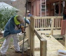 CAP volunteers make repairs to the 100th home following 2022 floods.