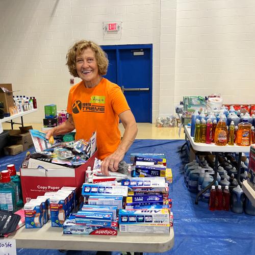 A volunteer sorts items for pickup at CAP's flood relief distribution center in Floyd County.