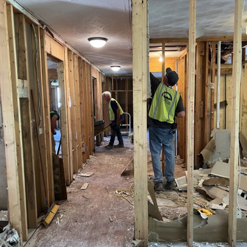 CAP Disaster Relief volunteers strip wet dry wall and insulation from a flooded home.