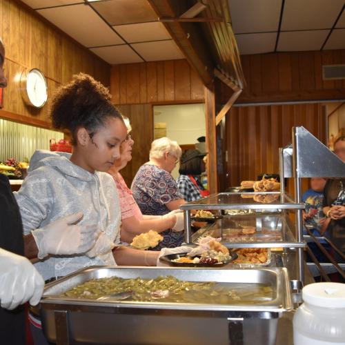 The Kitchen in Alabama helps feed people in need and distributes essential items from Operation Sharing to the community.